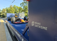 An F1 car takes to the streets of Riga on a special Rīgas satiksme tram platform